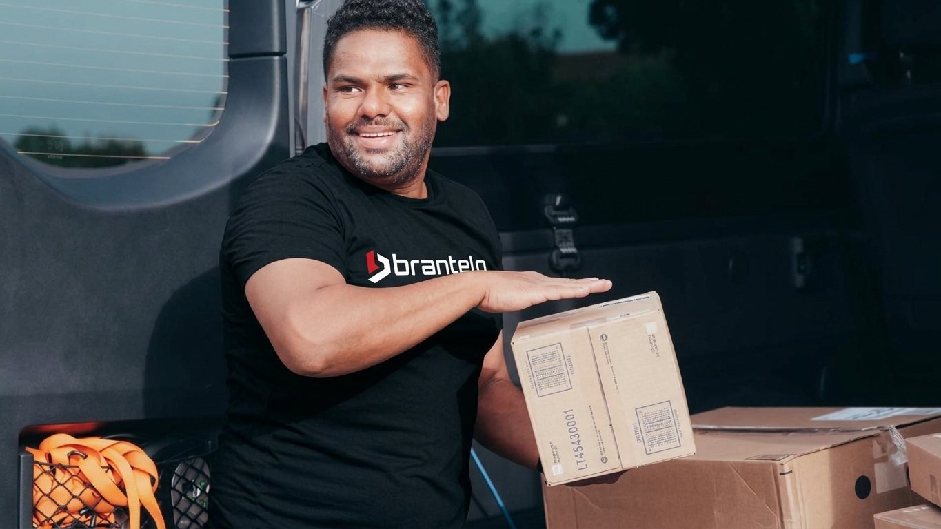 Brantelo courier delivering automotive and EV parts packages directly to a verified buyer